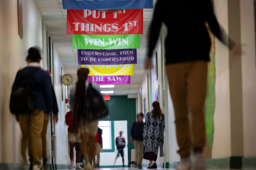 Students walking down a school hallway