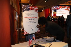One of the future servicemembers signs the Celebrate Freedom Week poster that welcomed guests.