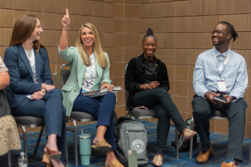 Educators seated in a discussion circle at Teacher Leader Summit, participating in a professional learning session.