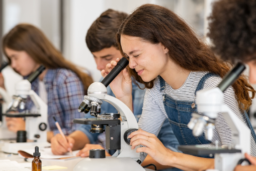 Student looking into microscope